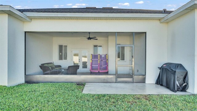 view of exterior entry with a patio, a ceiling fan, a shingled roof, stucco siding, and french doors