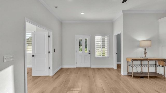 entrance foyer with crown molding, light wood-style flooring, and baseboards