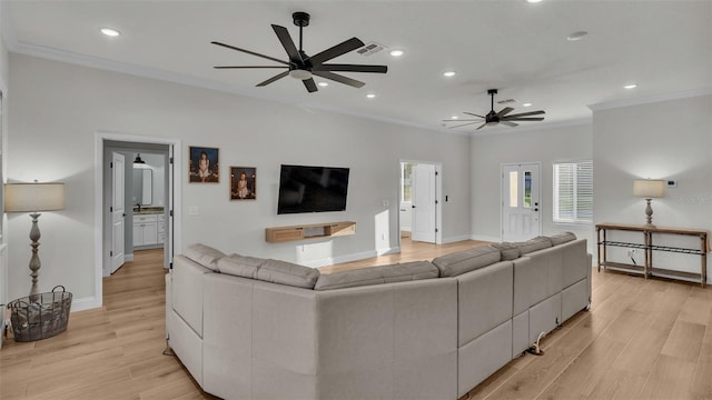 living room featuring crown molding, recessed lighting, light wood-style floors, and visible vents