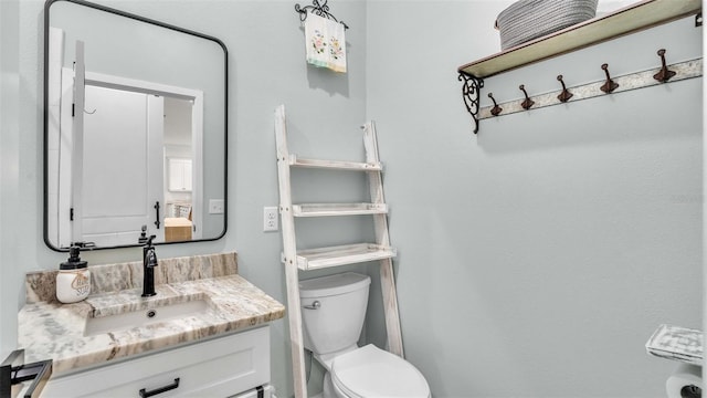 bathroom with toilet and vanity