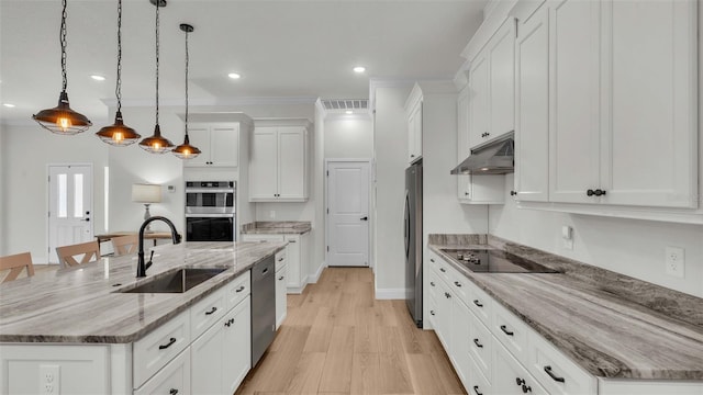 kitchen featuring a large island, a sink, under cabinet range hood, appliances with stainless steel finishes, and white cabinets