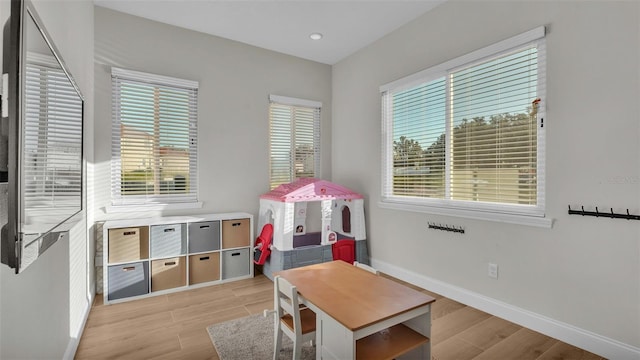 recreation room with recessed lighting, baseboards, and light wood-style floors