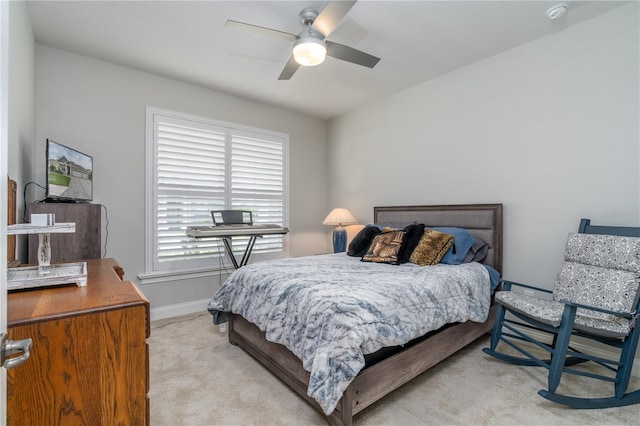 bedroom with light carpet and ceiling fan