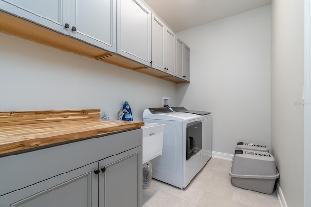 washroom featuring cabinets and independent washer and dryer