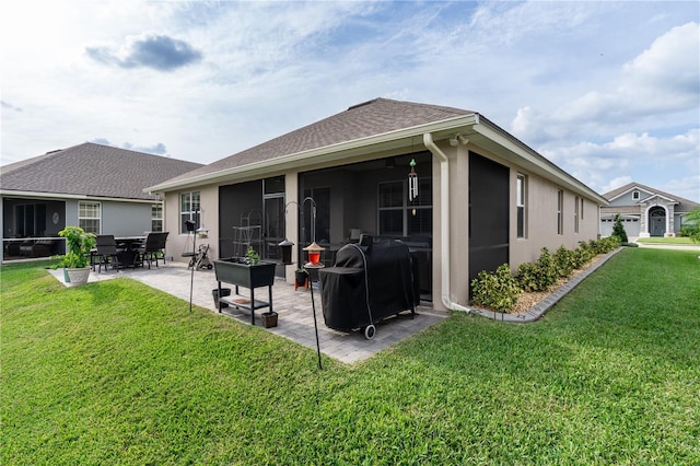 rear view of house featuring a yard and a patio