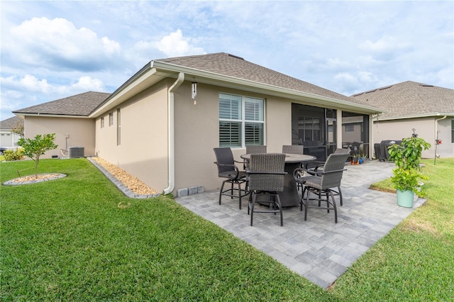 back of house featuring a patio, a sunroom, central air condition unit, and a lawn