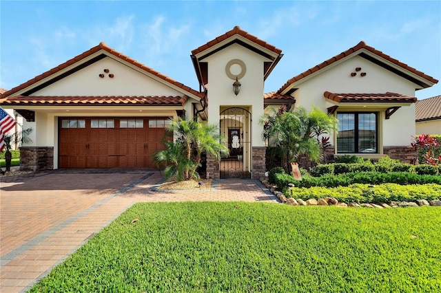 mediterranean / spanish-style home with a front yard and a garage