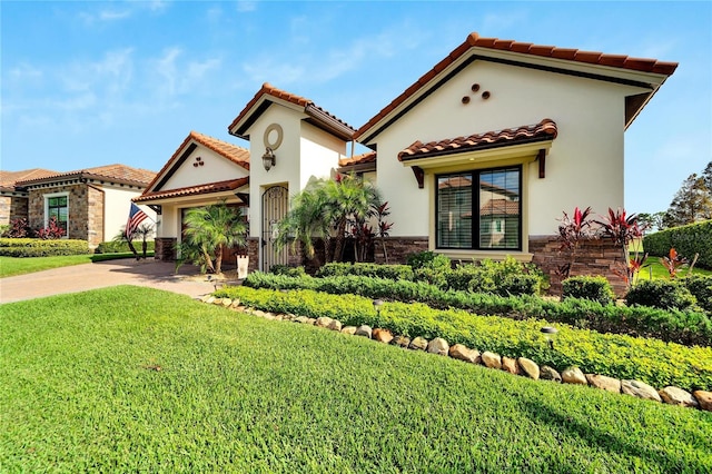 mediterranean / spanish-style house featuring a front lawn