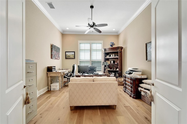 office area with ceiling fan, ornamental molding, and light wood-type flooring