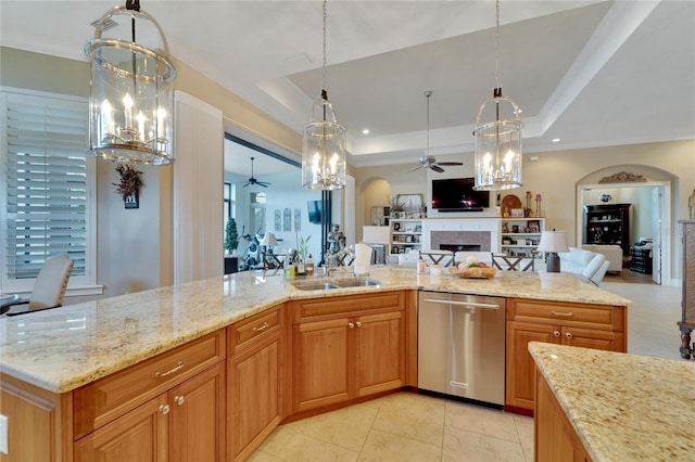 kitchen featuring sink, dishwasher, light stone countertops, and hanging light fixtures