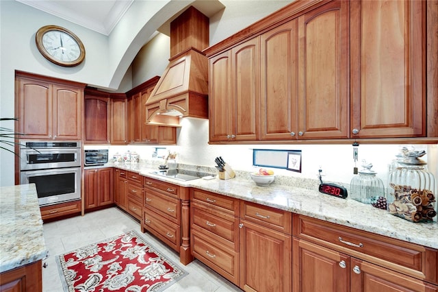 kitchen featuring stovetop, crown molding, light stone counters, and stainless steel double oven