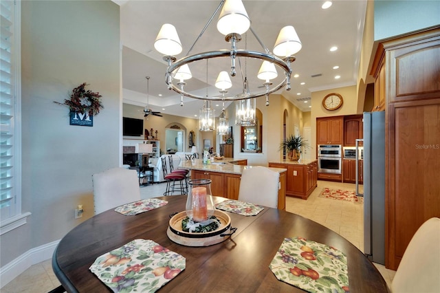 dining room featuring ornamental molding, light tile patterned floors, and ceiling fan with notable chandelier