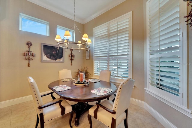 dining area with ornamental molding, a chandelier, and light tile patterned floors