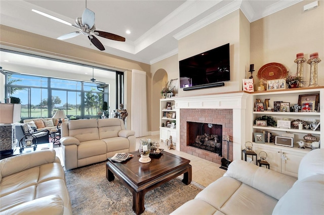 living room with crown molding, a fireplace, and ceiling fan