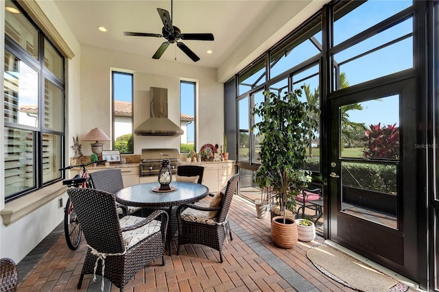 sunroom with a healthy amount of sunlight and ceiling fan