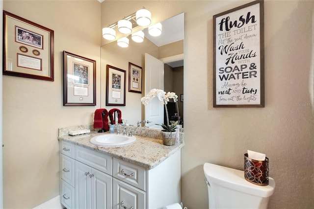 bathroom featuring toilet and vanity