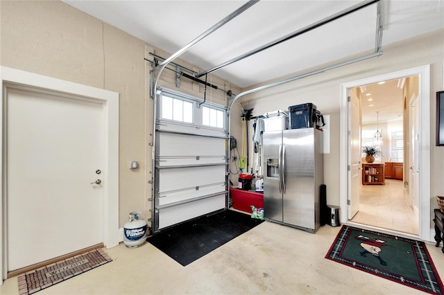 garage featuring stainless steel fridge with ice dispenser