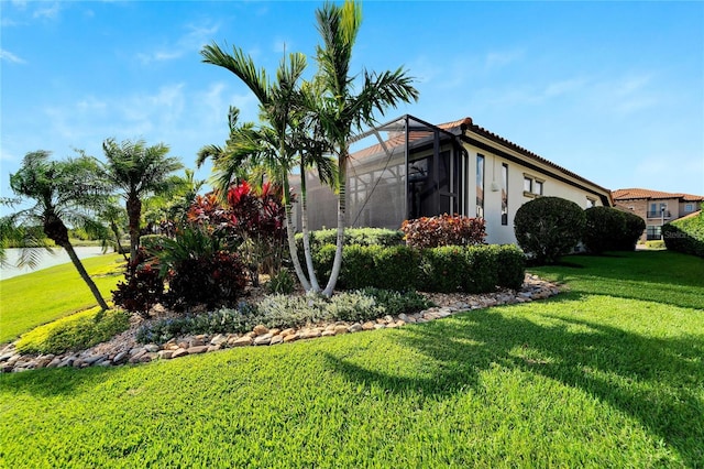 view of home's exterior featuring a yard and a lanai