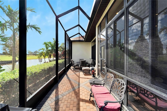 sunroom / solarium with a water view