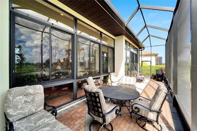 sunroom featuring lofted ceiling