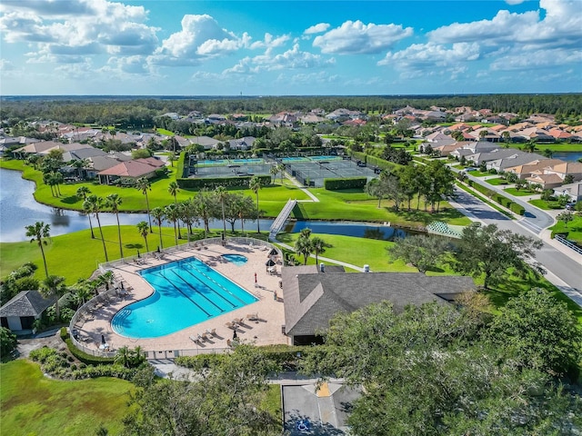 birds eye view of property with a water view