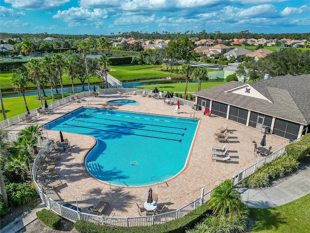 view of pool featuring a water view and a patio area