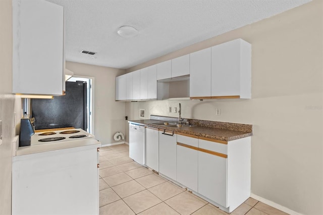 kitchen featuring white cabinetry, light tile patterned floors, sink, and white appliances