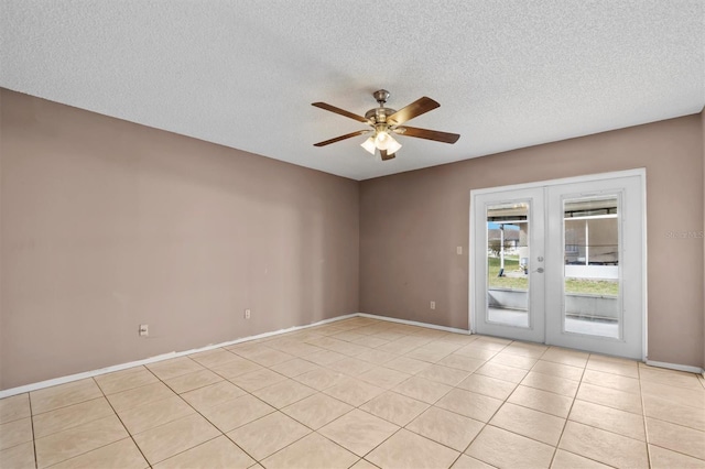 tiled empty room with french doors, a textured ceiling, and ceiling fan