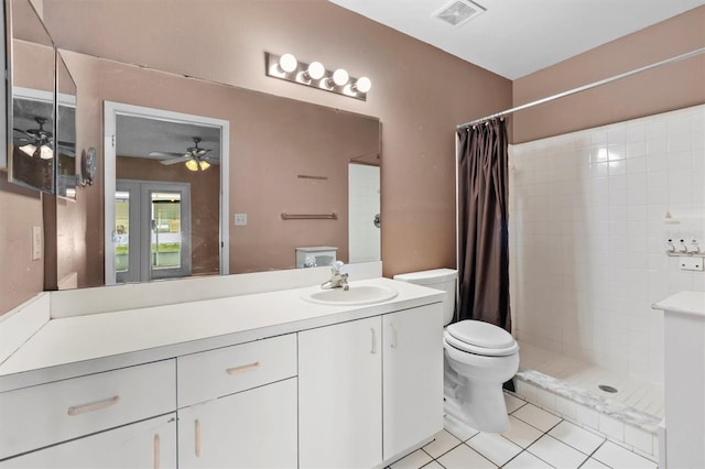 bathroom with vanity, toilet, walk in shower, and tile patterned flooring