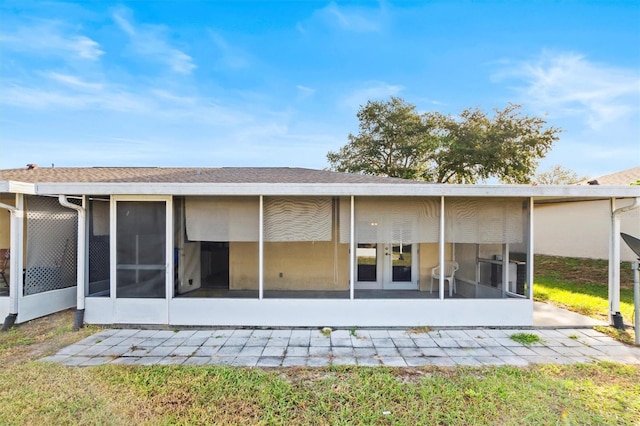 rear view of house featuring a sunroom