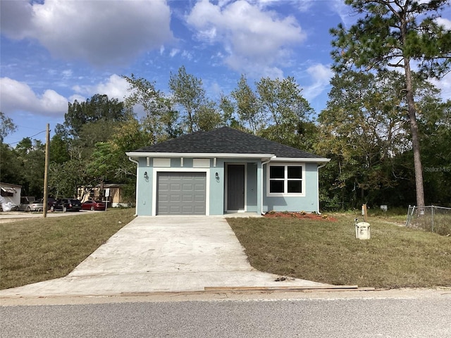 view of front facade featuring a front lawn and a garage