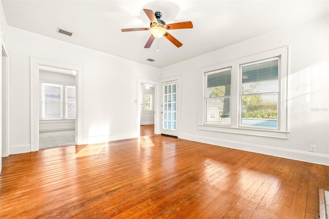 empty room with light wood-type flooring and ceiling fan