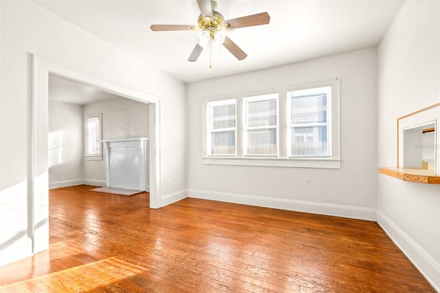 unfurnished living room featuring ceiling fan and wood-type flooring