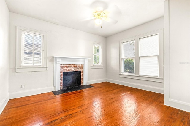 unfurnished living room featuring hardwood / wood-style floors, a fireplace, and ceiling fan