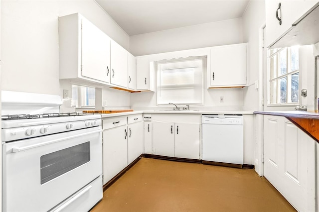 kitchen with white appliances, white cabinetry, a wealth of natural light, and sink