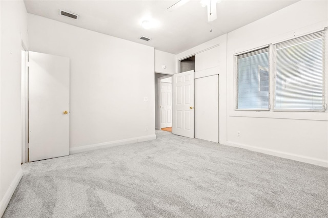 unfurnished bedroom with light carpet and ceiling fan