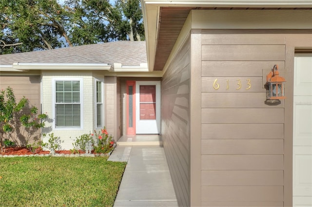 doorway to property featuring a lawn