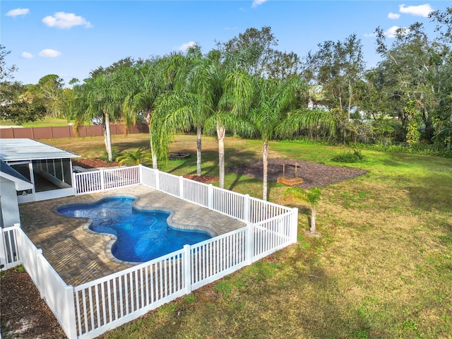 view of swimming pool with a lawn and a patio