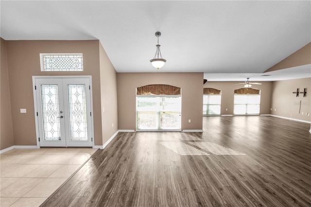 foyer entrance with french doors, light wood-type flooring, ceiling fan, and a healthy amount of sunlight