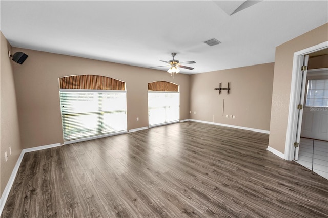 empty room featuring ceiling fan and dark wood-type flooring