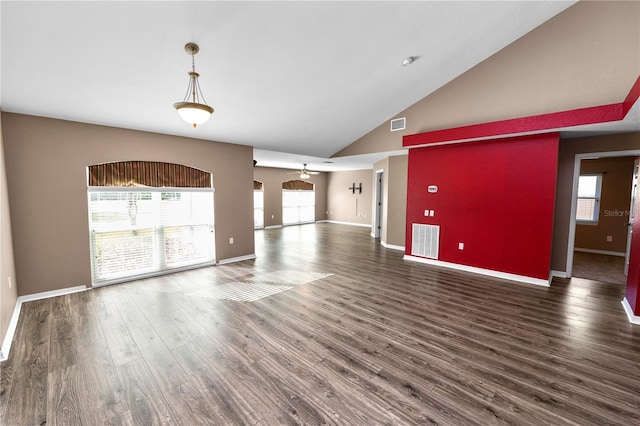 unfurnished living room featuring ceiling fan, dark wood-type flooring, high vaulted ceiling, and a healthy amount of sunlight