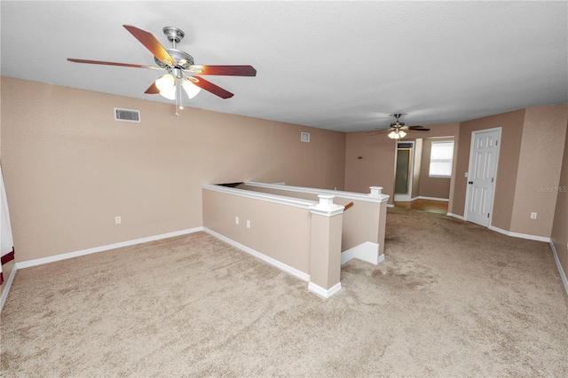 unfurnished room featuring light carpet and ceiling fan