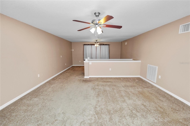 carpeted empty room featuring ceiling fan