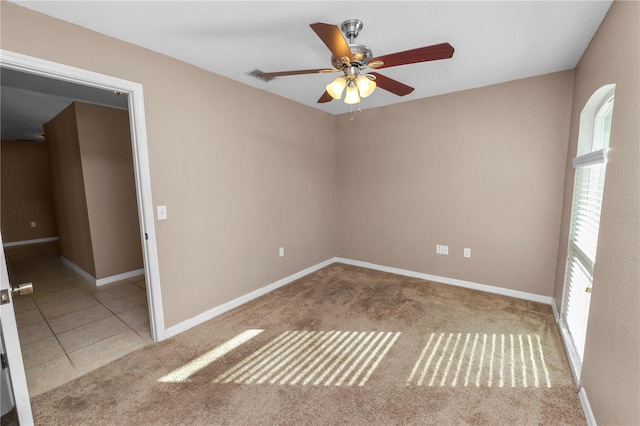 unfurnished room with ceiling fan and light carpet