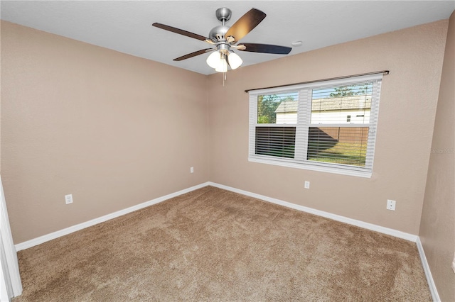 carpeted empty room featuring ceiling fan