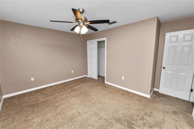 unfurnished bedroom with ceiling fan, carpet floors, and a closet