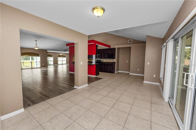 empty room featuring light hardwood / wood-style flooring and vaulted ceiling