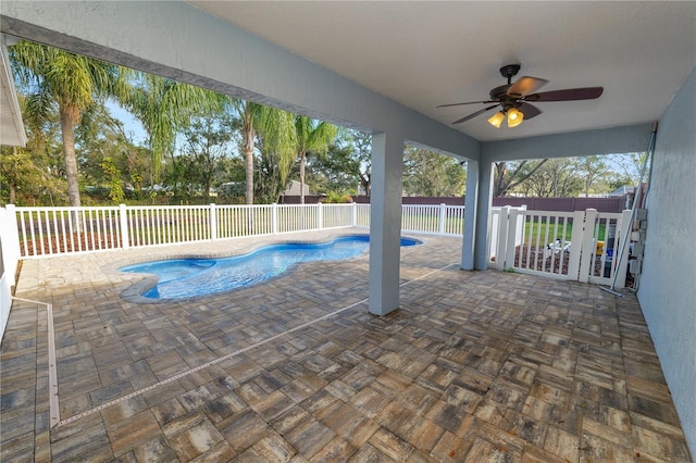 view of pool with ceiling fan and a patio