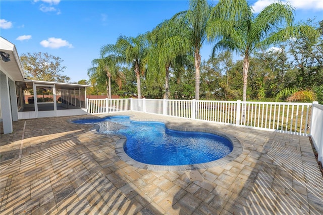 view of swimming pool with a sunroom and a patio