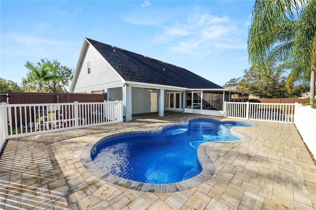 view of swimming pool featuring a patio area and a sunroom